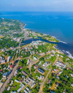 Aerial view of Kribi coastline showing the town, Atlantic Ocean, and lush greenery in Cameroon